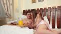 Girlfriend in lingerie brings partner breakfast pancakes in bed Video