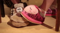 Couple's feet in funny novelty slippers playing under table Video