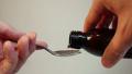 Measuring liquid medicine with a teaspoon, taking cough syrup Video