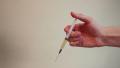 Close-up hand holding a syringe, doctor giving an injection Video