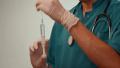 Doctor's hands in white gloves hold syringe ready for injection Video