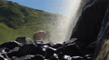 Woman tourist washing her face with fresh waterfall water Video