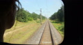 Woman looking through coach window at railway tracks, leaving Video