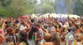Dancing crowd covered in colorful paint, people enjoying fest Video