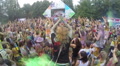 People spraying colored powder paint at festival, slow motion, click for HD Video