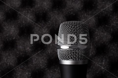 Wireless Microphone Closeup On Foam Acoustic Background