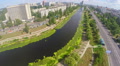Panoramic view of river channel, cars driving city road, aerial Video