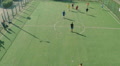 Group of young men playing soccer on pitch, sports aerial Video