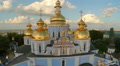 Church with golden domes and crosses, city panorama aerial Video