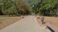 Deserted alley in park, daytime, no people, flying above ground Video