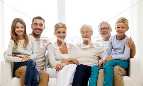 Happy Family Sitting On Couch At Home