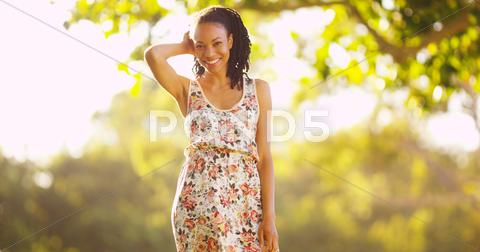 Happy Black Woman Standing On Grass