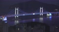 Aerial of Gwangan Suspension Bridge At Night Colored Lights 4K Video