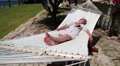 Woman lying in the hammock near sea shore Video