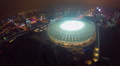 Aerial of large illuminated stadium at night, city landmark Video