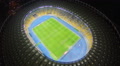 Amazing soccer stadium, glowing lights at night, aerial view, 4k Video