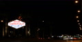 Drive Carefully Come Back Soon Las Vegas Neon Sign Cars Passing Night Traffic Video