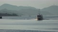 Small Boat Apporches Dock At Sunset Mountain Island In Background 4K Video