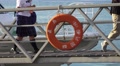 People Walk Off Passenger Ferry Walkway From Boat Dock With Life Preserver 4K Video