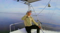 Adult male in sunglasses enjoying rest on sailboat, holiday Video