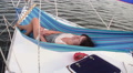 Attractive woman relaxing in hammock on sailing boat, traveling Video