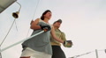 Male and female holding hands on sailing yacht, support, team Video