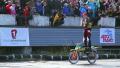 Stunt person plays accordion while standing on moving motorcycle Video