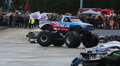 Monster truck huge wheels crashing junk cars, entertaining crowd Video