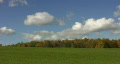 Beautiful field w/ timelapse clouds. Footage