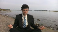 Businessman meditates at the beach. Footage