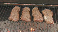 Steaks cooking on charcoal grill clip 6 Footage