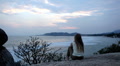 A meditative and romantic blonde girl relaxing waching the sea Footage