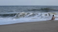 Beautiful girl relaxing in big waves on exotic beach Footage