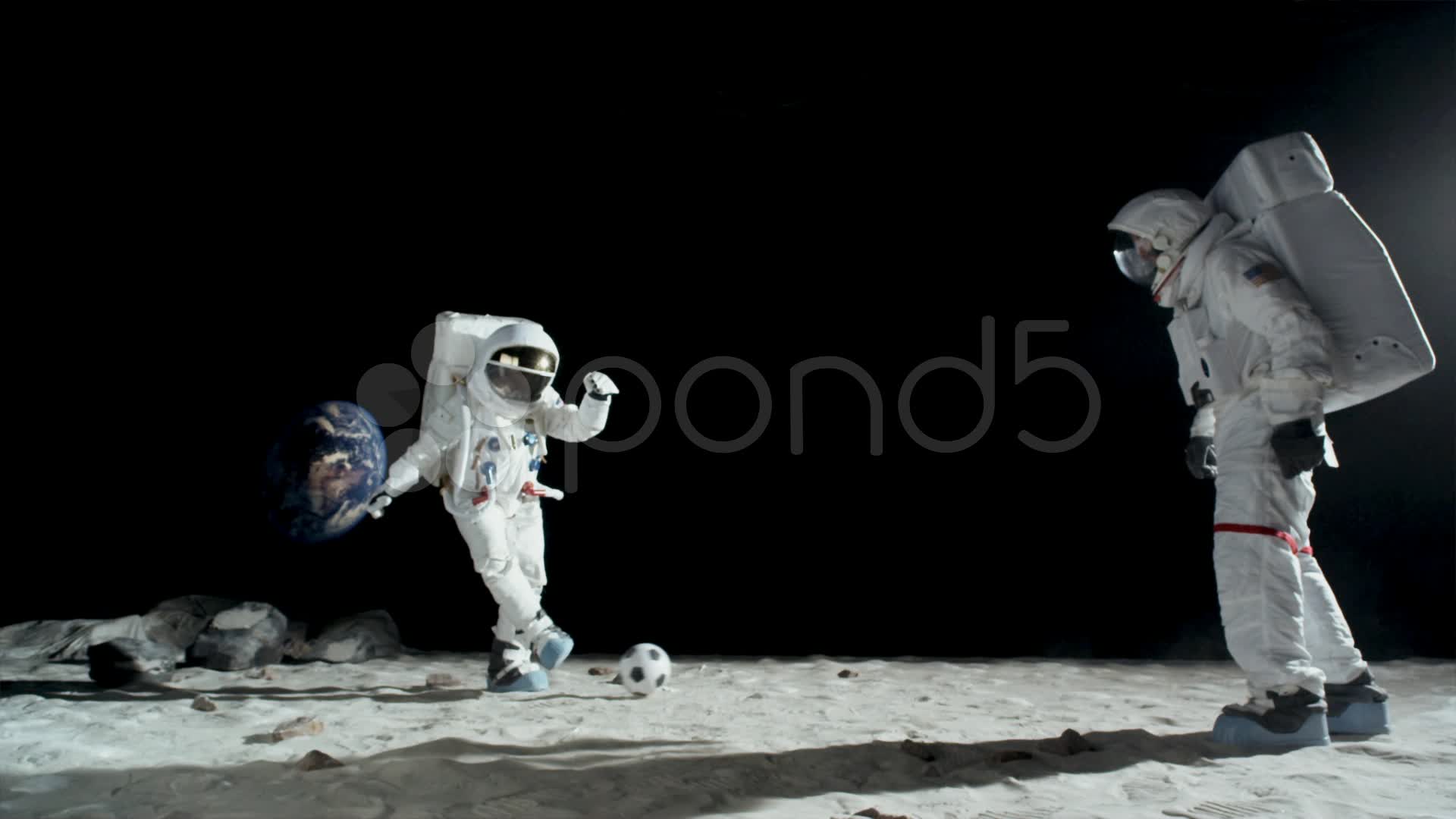 SLO MO, WS, Lockdown of two astronauts on the moon playing soccer