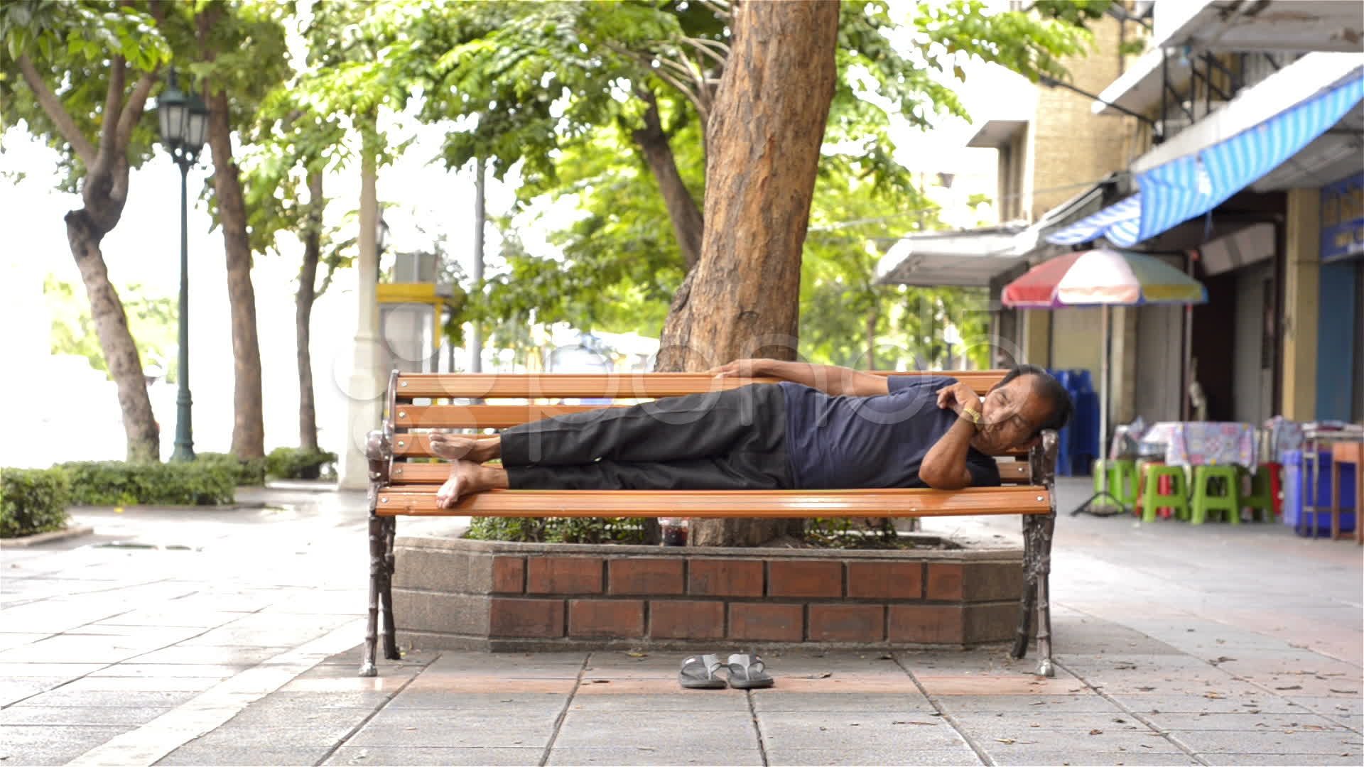 Homeless Man Sleeping On Bench On Sidewalk Fusion Footage