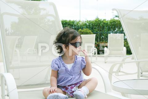 Stock Illustration of adorable young baby girl wearing sunglasses in flirting position