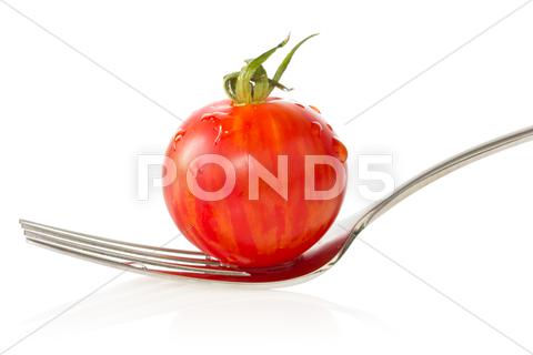Stock photo of cherry tomato on a fork