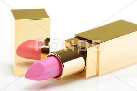 Stock photo of pink golden lipstick over white