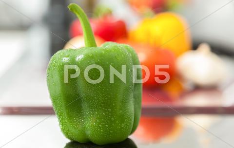 Stock photo of fresh green pepper covered with water drops