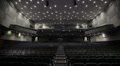 Man applauds alone in the theater. Wide shot. Video