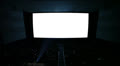 White cinema screen with projector light and audience in a modern cinema house. Video