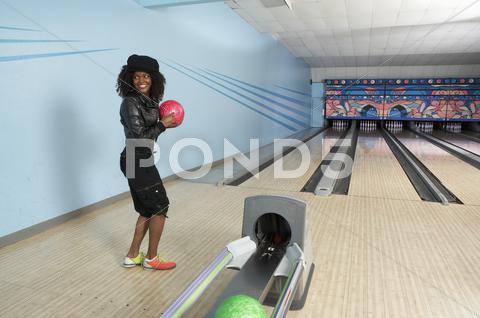 Stock photo of Young Woman At Bowling Ball