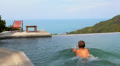 Man Relaxing and Swimming in Endless Luxurious Pool Video