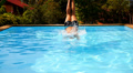 Muscular Man Jumping into the Blue Water in Outdoor Pool near Luxury Resort. Video
