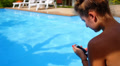 Young Woman Texting on the Phone while Relaxing in Private Pool near Luxury Video