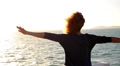 Girl Spreading Hands with Joy and Inspiration Facing the Sun. Spectacular Video
