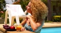 Attractive Woman Enjoying Juice and Sunbathing in Swimming Pool in Resort. Video