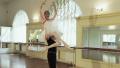 Male ballet dancer carries ballerina with her arms above head Video