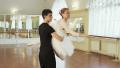 Elderly woman dancing ballet with young man in gym, slow-mo Video