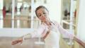 Elderly ballerina holds on to barre and practices ballet moves Video